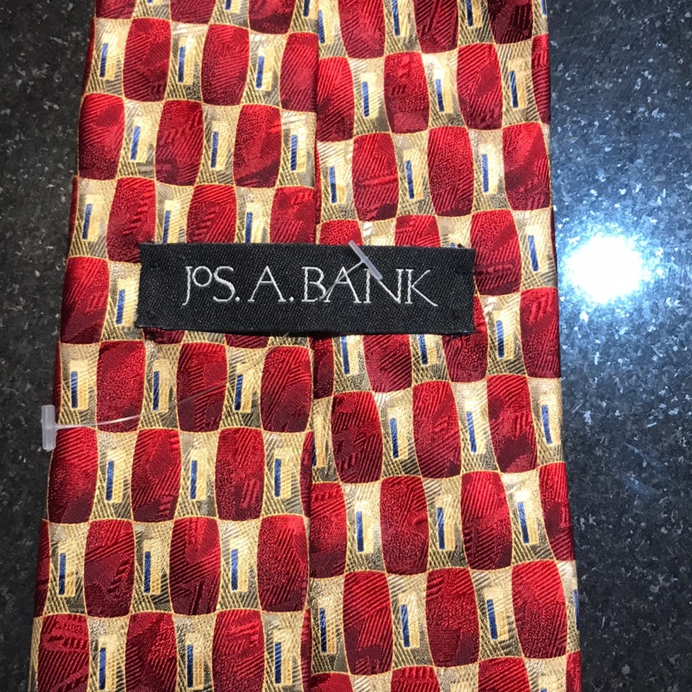JOS A Bank men’s tie.  Burgandy-ish/red and yellow